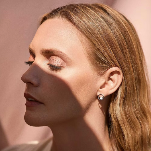 Model wearing Joma Jewellery June Birthstone moonstone stud earrings, symbolising balance and new beginnings.