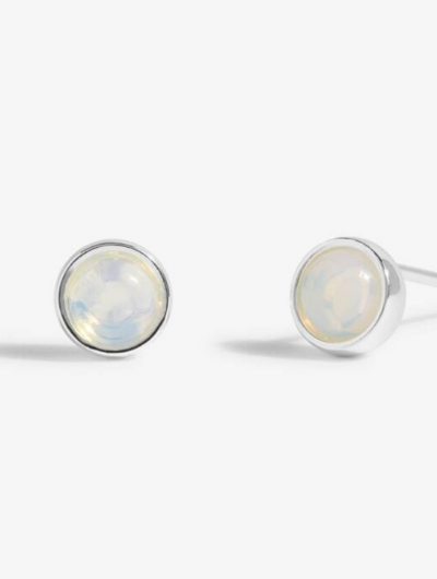 Close-up of Joma Jewellery June Birthstone Earrings featuring Moonstone and month traits card.