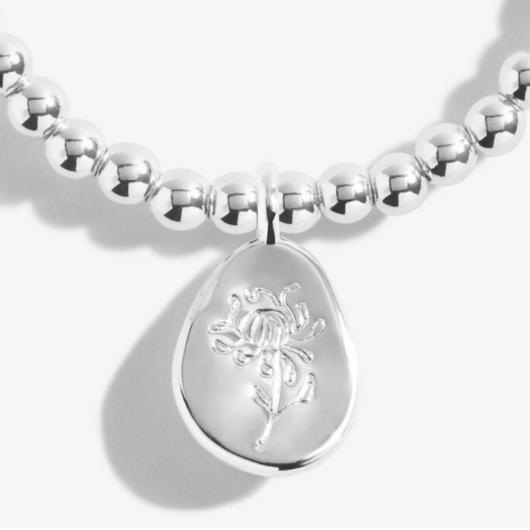 Joma Jewellery Birth Flower November Chrysanthemum silver-plated bracelet with engraved oval charm on pastel sentiment card.