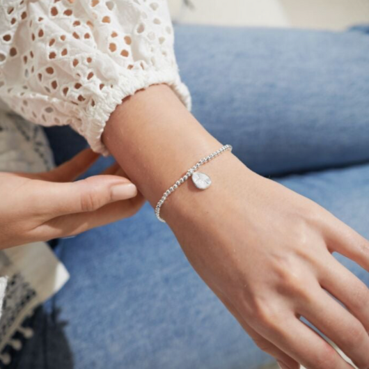 Joma Jewellery Birth Flower January Snowdrop silver-plated bracelet with engraved oval charm on pastel sentiment card.