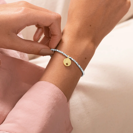 Radiance A Little One In A Million bracelet with gold star cutout charm on sentiment card.