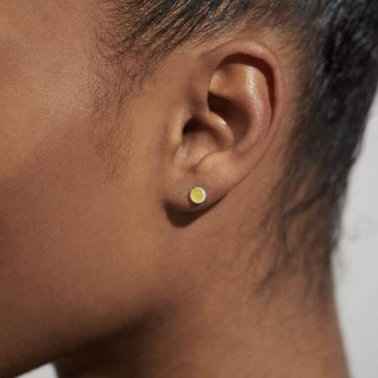 Close-up of Joma Jewellery November Birthstone Earrings with Yellow Quartz stones and traits card.