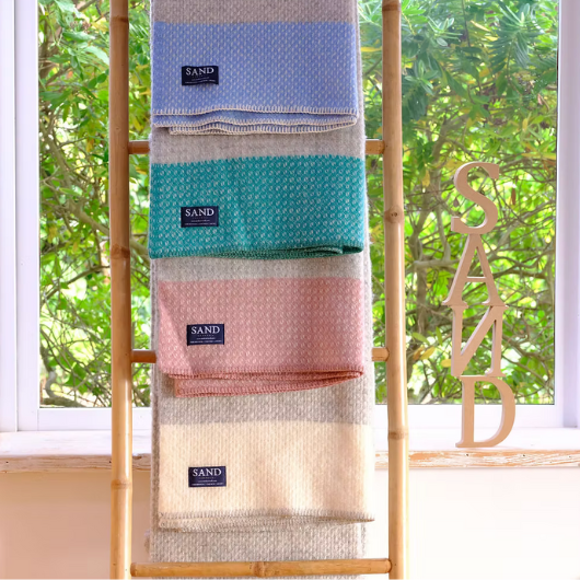 Crossweave Dusty Pink and Light Grey Wool Cornwall Throw Blanket draped on a sofa