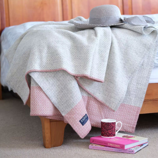 Crossweave Dusty Pink and Light Grey Wool Cornwall Throw Blanket draped on a sofa