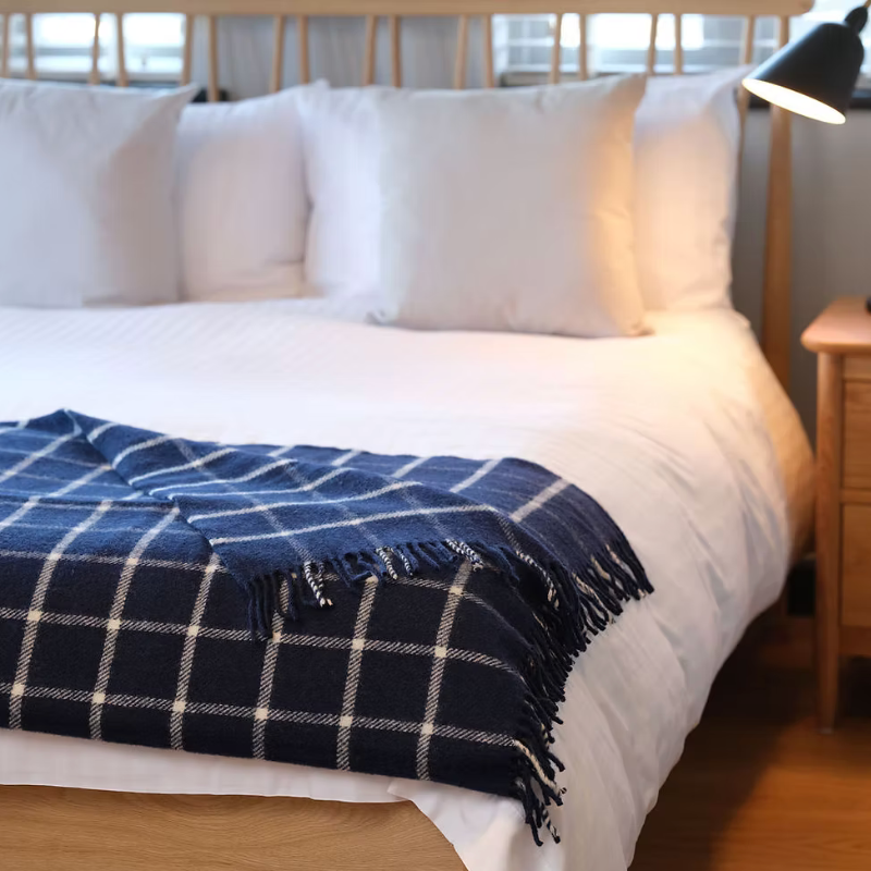 Navy chequered check pure new wool blanket throw with tasselled edge.