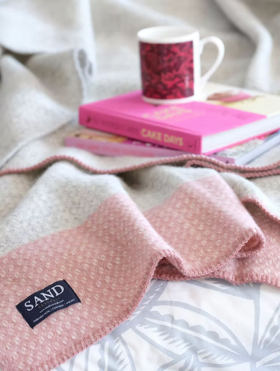 Crossweave Dusty Pink and Light Grey Wool Cornwall Throw Blanket draped on a sofa