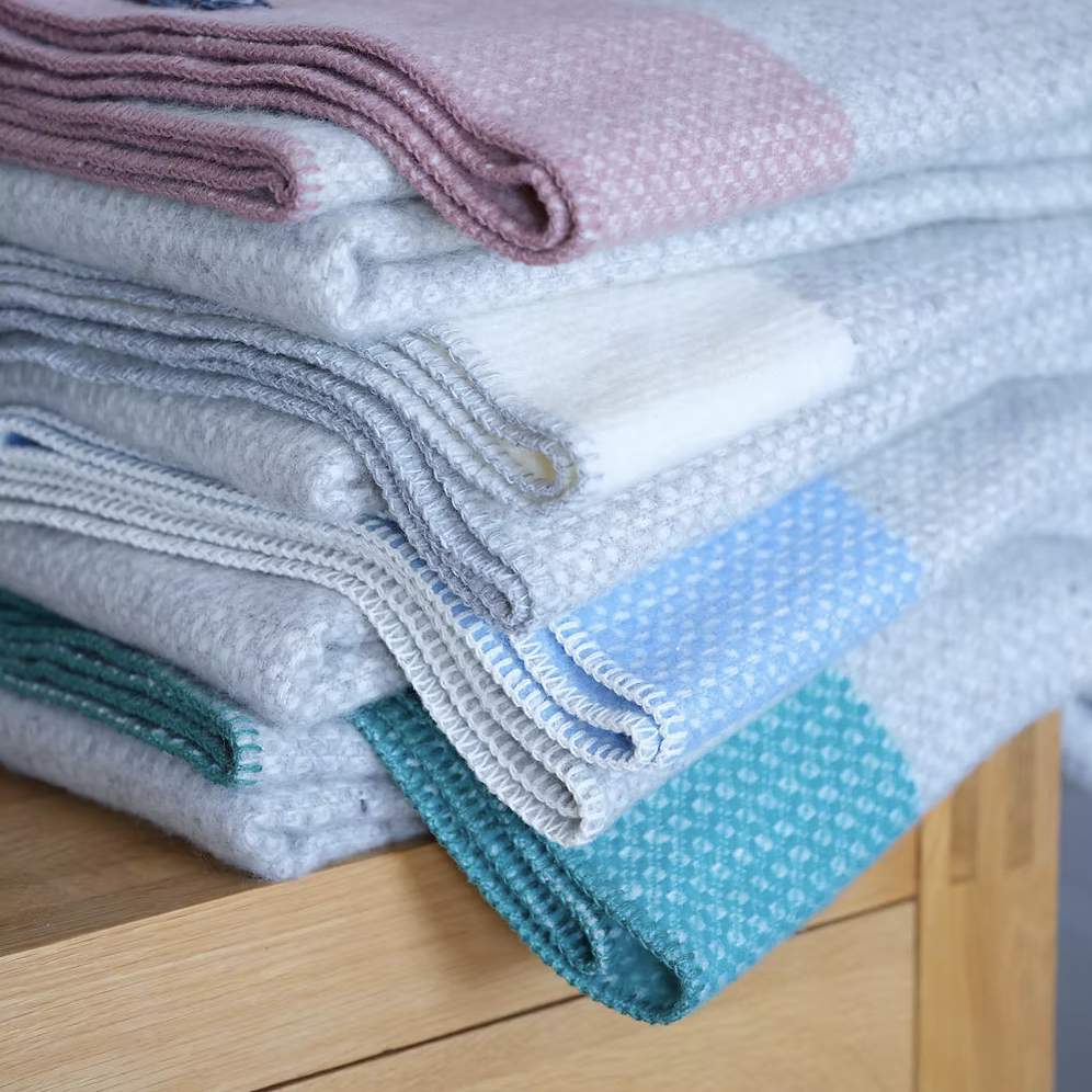 Crossweave Sea Blue Pure New Wool Blanket Throw with light grey base and bright blue stripe, folded neatly.