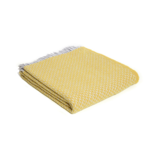 Yellow Diamond Wool Blanket Throw with twisted tassels draped on sofa