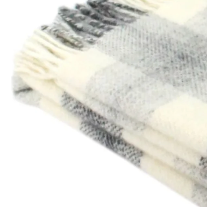 Soft wool check-patterned blanket with fringe edging.