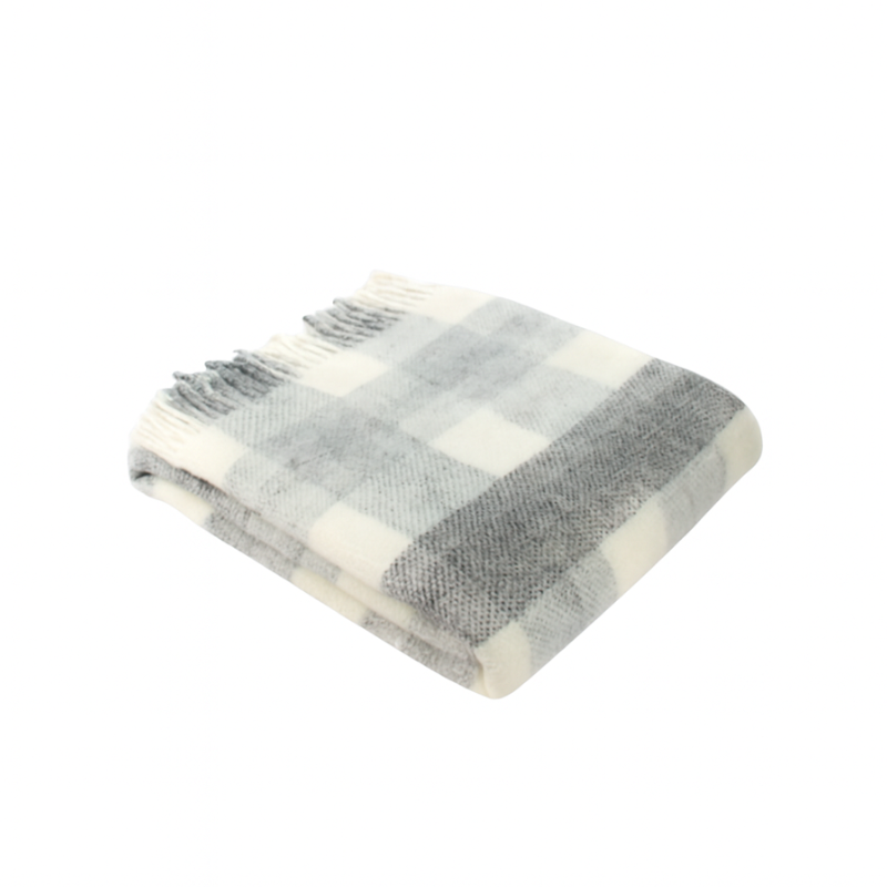 Soft wool check-patterned blanket with fringe edging.