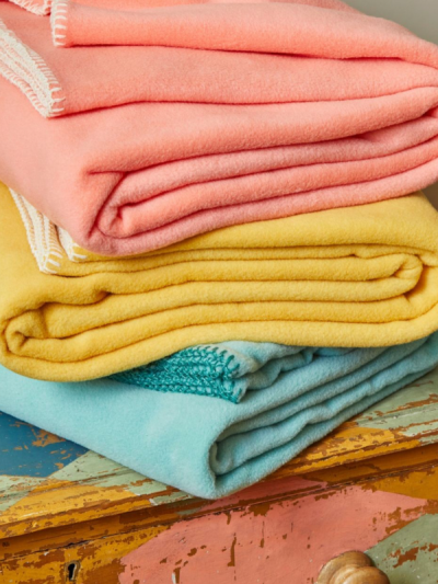 Sand Cornwall fleece throws folded neatly with soft fleece texture