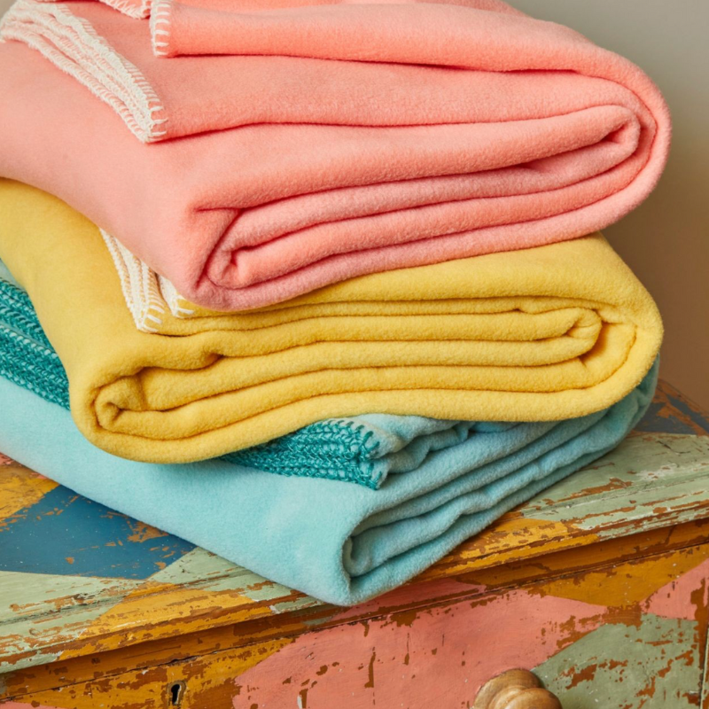 Sand Cornwall fleece throws folded neatly with soft fleece texture