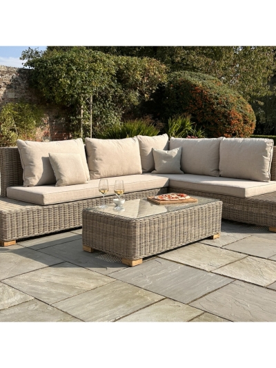 Capri Collection large outdoor corner sofa set with matching coffee table arranged on a modern garden patio.