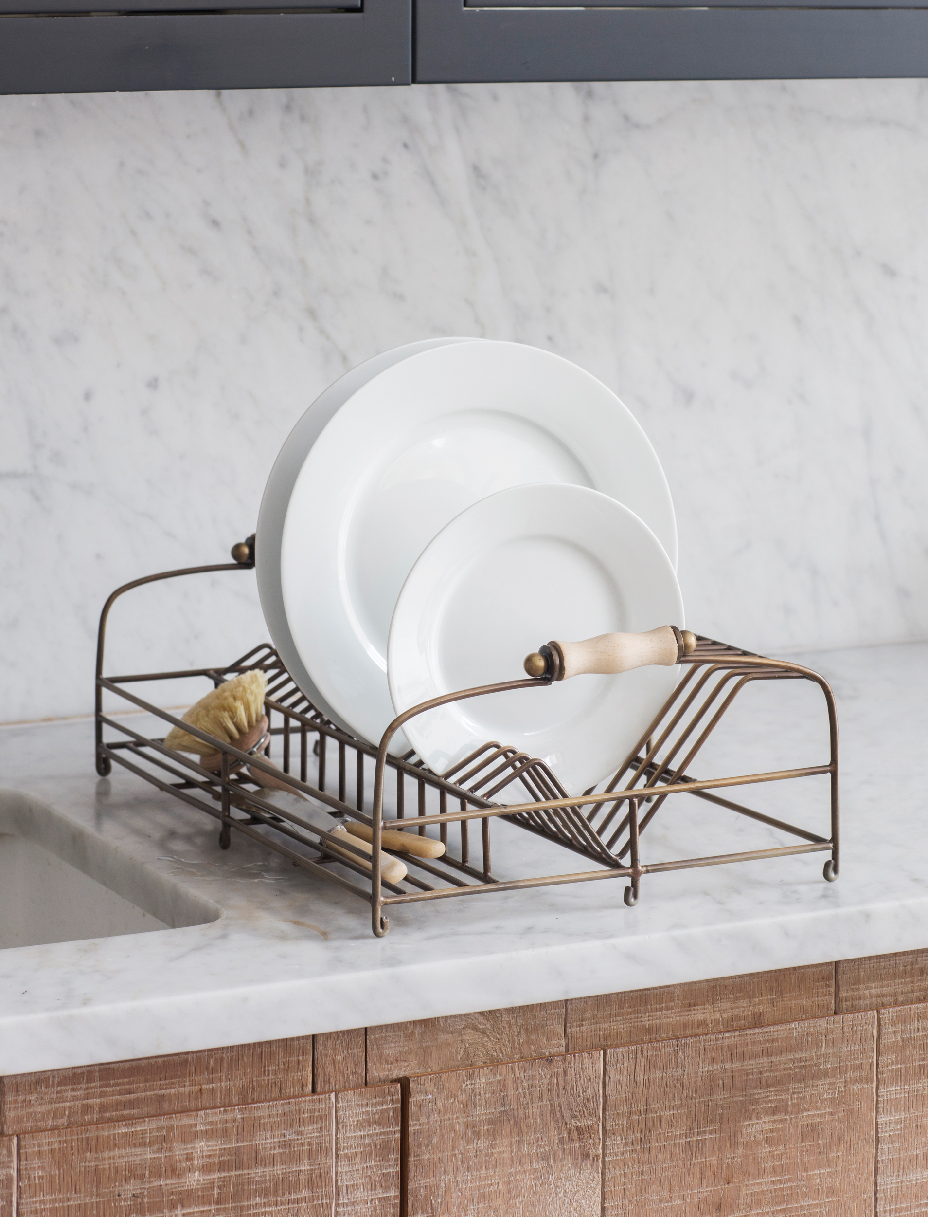 Garden Trading Brompton wirework dish rack with antique brass finish, wooden handles, and plate storage compartments.